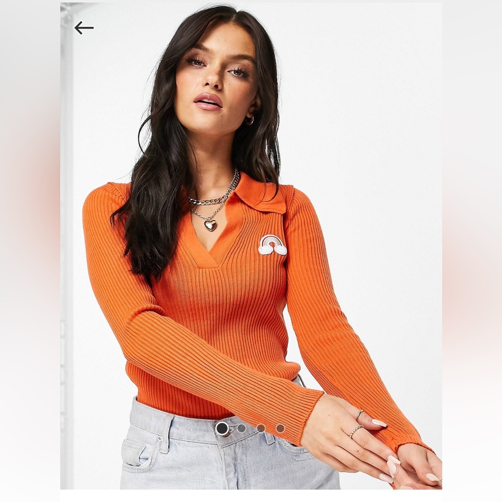 orange ribbed collar v neck with rainbow badge long sleeve